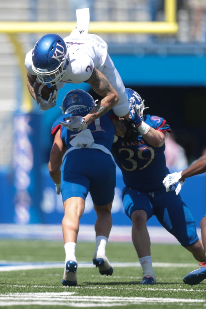 Kansas redshirt sophomore wide receiver Lawrence Arnold (2) jumps defenders during Saturday's spring game at David Booth Kansas Memorial Stadium.